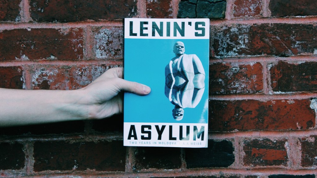 Picture of Independent Book Review editor-in-chief Joe Walters holding copy of Lenin's Asylum by A.A. Weiss